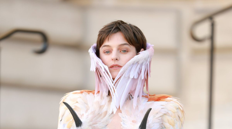 Emma Corrin Strips Down in Audacious Feathered Getup at Paris Fashion Week