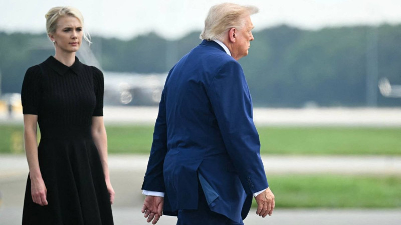 Donald Trump's Stylish 'Nurse Aide' Seen Carrying the President's 'Diaper Bag'
